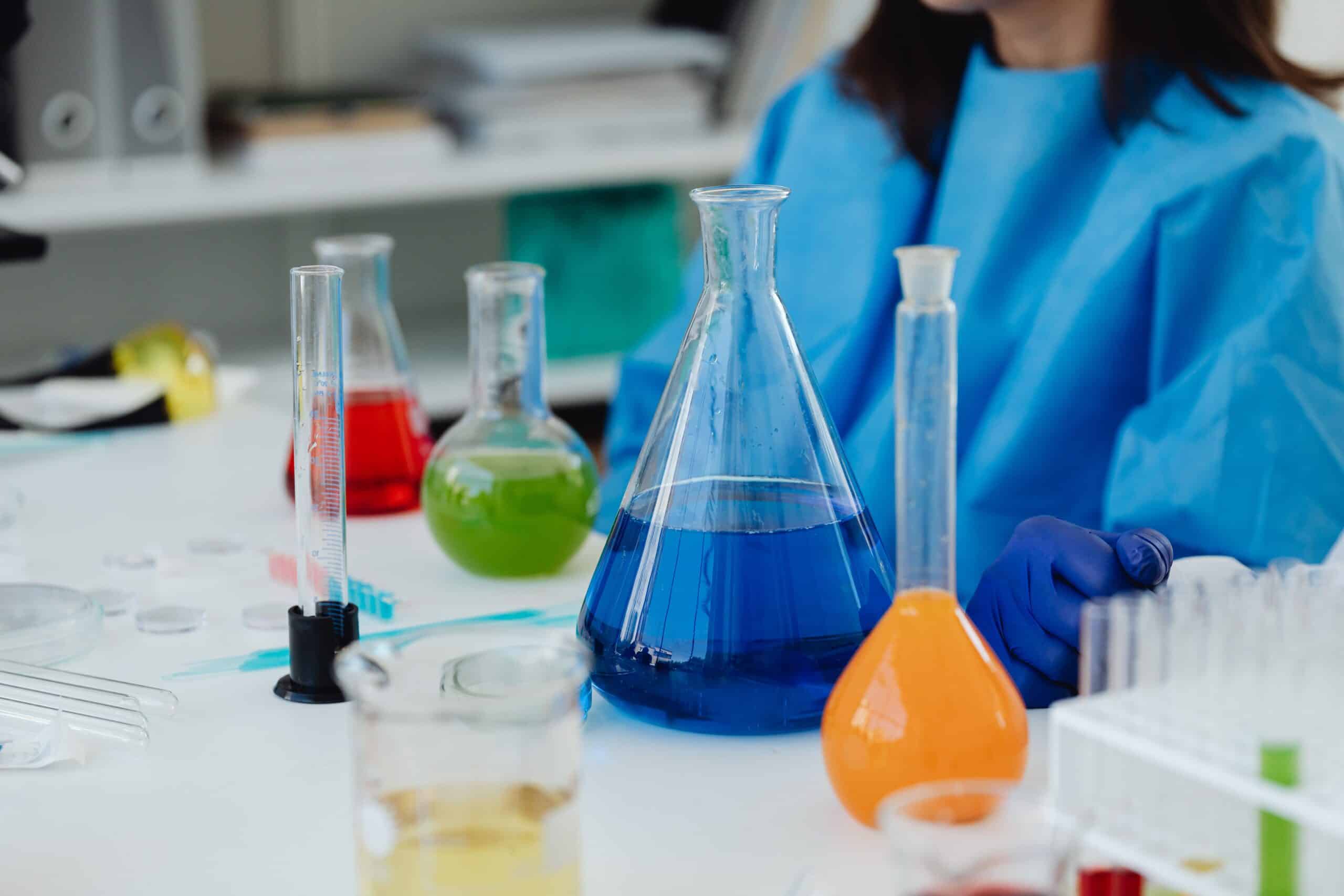 Laboratory glassware with colorful liquids used in telehealth research.